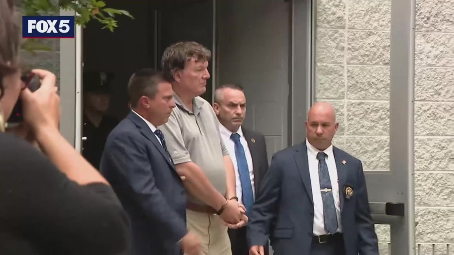 Suspect Gilgo Beach serial killer Rex Heuermann with authorities.