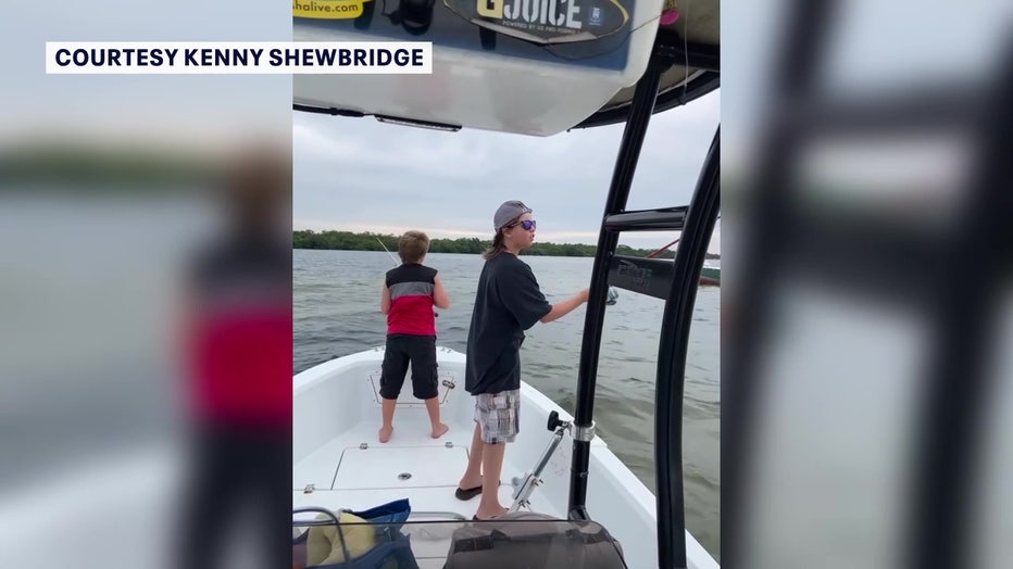 James and Hunter Ganey fishing on boat.