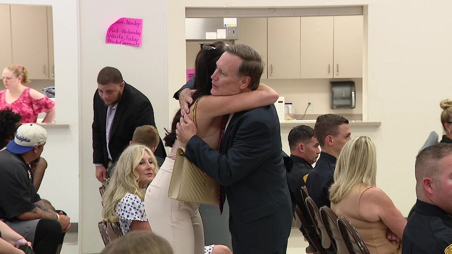 Charles McKeon embraces the woman he saved from the attack.