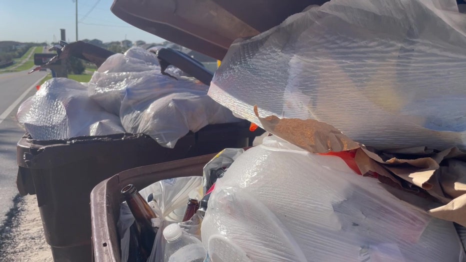 File: Trash piled up in a Polk County garbage can. 