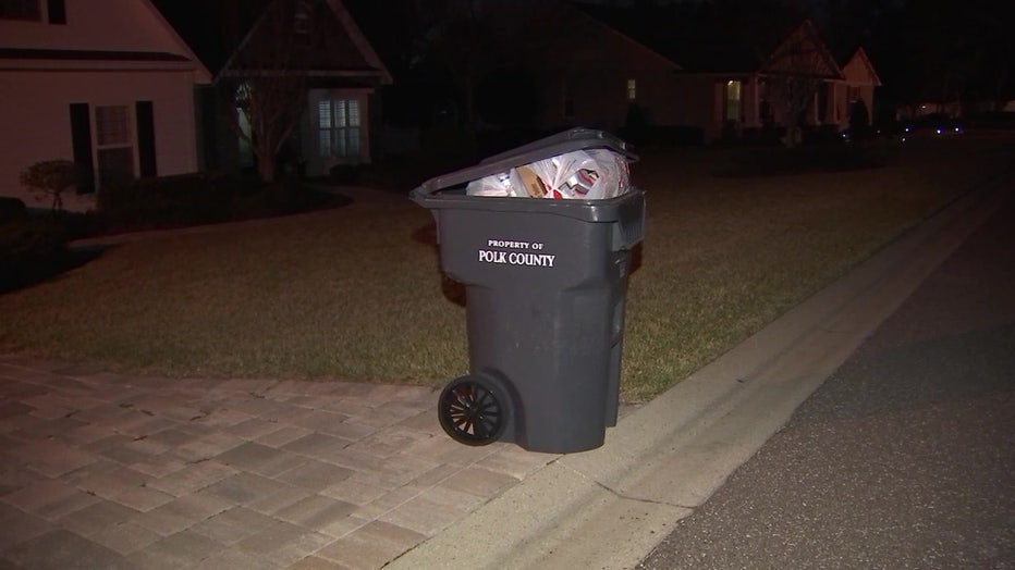 File: Trash piled up in a Polk County garbage can.