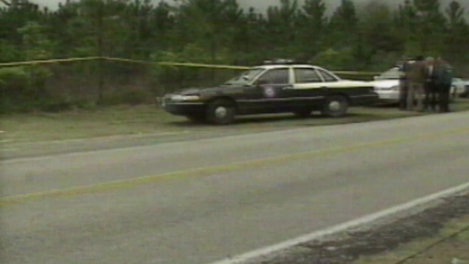 File: 1993 image of a patrol car and crime scene tape outside the orange grove where Odom's body was found. 