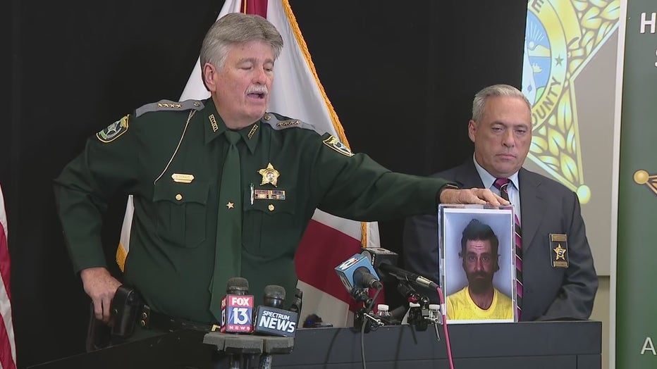 Sheriff Al Neinhuis holding an old mugshot of Crum in hopes more victims will come forward. 