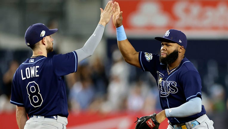 NEW YORK, NY - AUGUST 1: Manuel Margot #13 of the Tampa Bay Rays high-fives Brandon Lowe #8 of the Tampa Bay Rays after the Rays defeated the New York Yankees at Yankee Stadium on August 1, 2023 in New York City. The Rays won 5-2. (Photo by Adam Hunger/Getty Images)