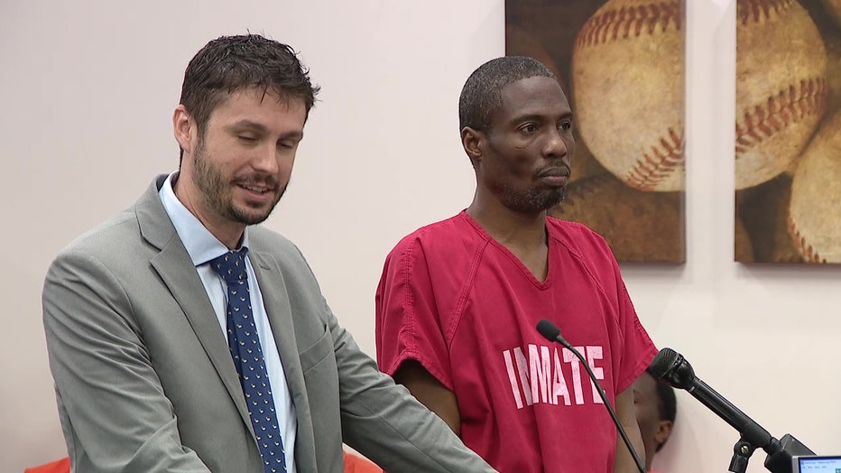 Teddy Baltimore Smith standing next to attorney in a Tampa courtroom. 