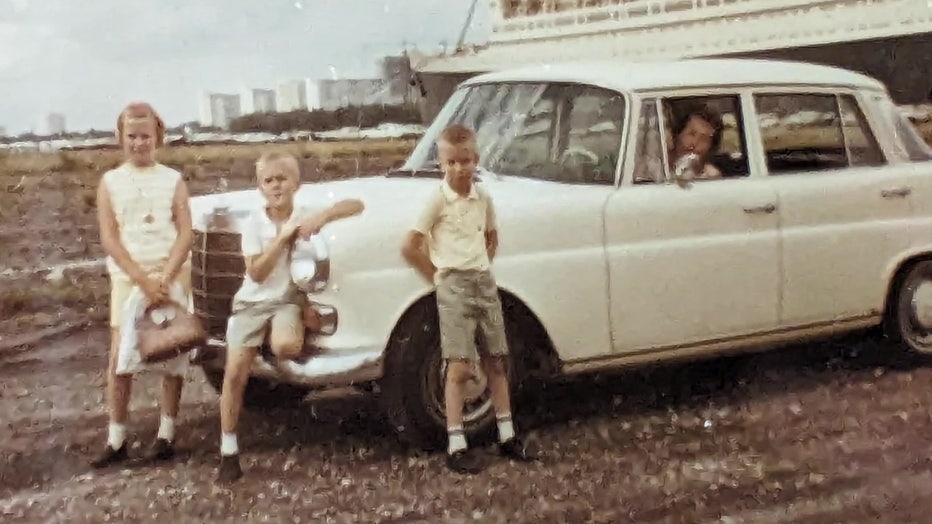 Sue Byanski Johnson and siblings pose near car during a family road trip.