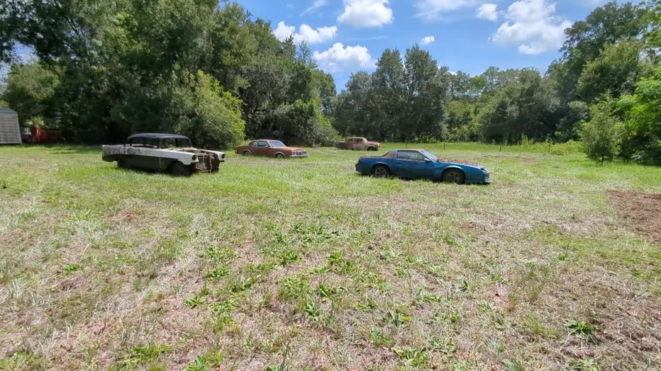 Vehicles still sit on the Valrico property.