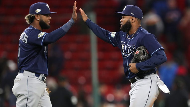 BOSTON, MASSACHUSETTS - SEPTEMBER 26: Manuel Margot #13 and Junior Caminero #1 of the Tampa Bay Rays celebrate after defeating the Boston Red Sox at Fenway Park on September 26, 2023 in Boston, Massachusetts. (Photo by Paul Rutherford/Getty Images)