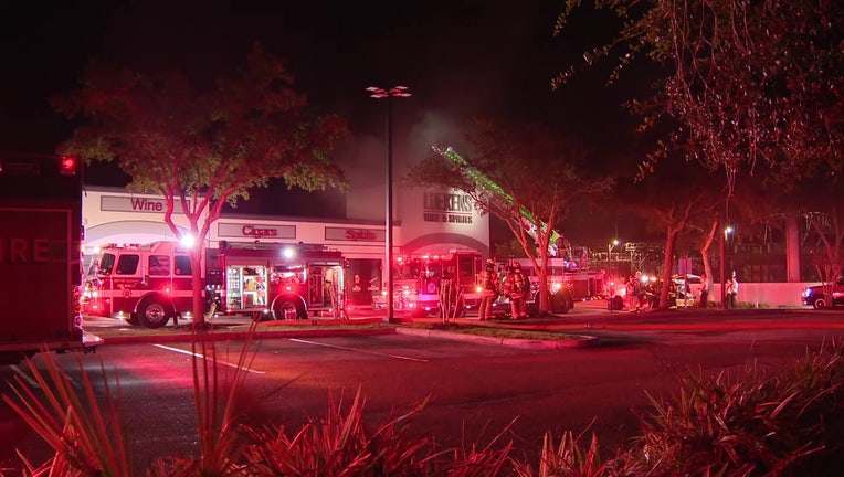 Firefighters work to put out at fire at Luekens Wine and Spirits in Oldsmar.