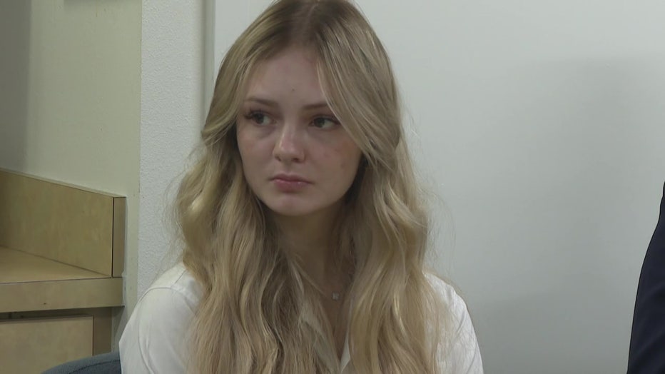 Maya Kowalski sits at a conference table ahead of jury selection. 