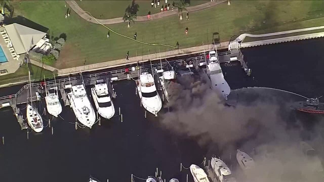 Crews working to extinguish massive boat fire at Gulfport yacht club