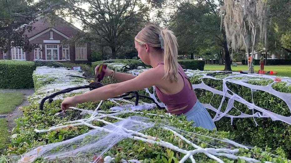 Woman decorates for the Spooky Stroll.