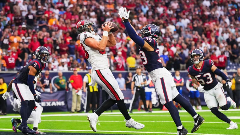 HOUSTON, TX - NOVEMBER 05: Cade Otton #88 of the Tampa Bay Buccaneers catches a touchdown pass against the Houston Texans during the second half at NRG Stadium on November 5, 2023 in Houston, Texas. (Photo by Cooper Neill/Getty Images)