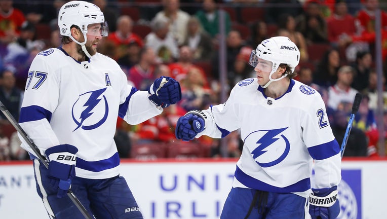 CHICAGO, IL - NOVEMBER 16: Brayden Point #21 of the Tampa Bay Lightning fist bumps Victor Hedman #77 of the Tampa Bay Lightning after scoring a goal during the second period against the Chicago Blackhawks at the United Center on November 16, 2023 in Chicago, Illinois. (Photo by Melissa Tamez/Icon Sportswire via Getty Images)