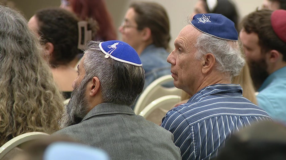 Attendees listen to Rabbi Mendy Dubrowski of Chabad Chai South Tampa. 