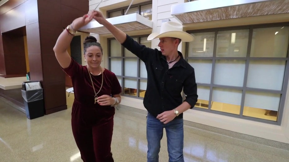 Kyle Higginbotham spins his dance instructor around the dance floor. 