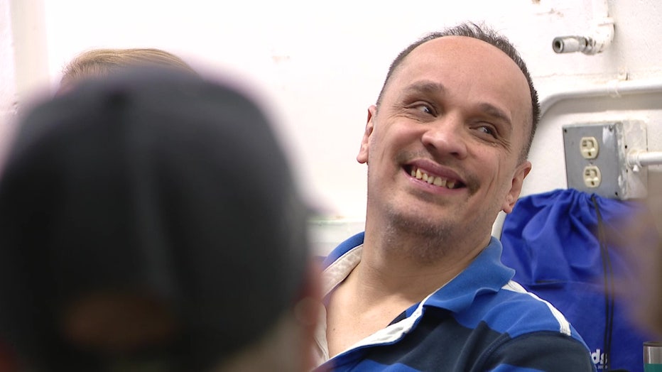 A man at Parc smiles during a card game. 