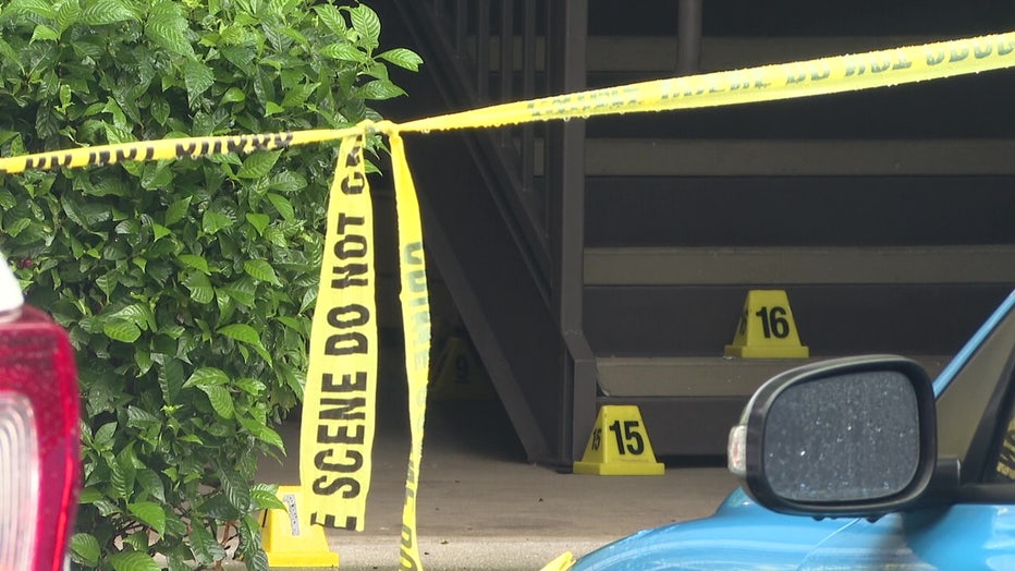 Crime scene tape outside apartment where a woman and a teen were stabbed to death. 