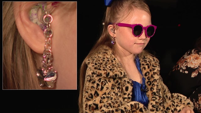Pediatric cancer survivor bullied by classmates boosts confidence by making hearing aids fun, stylish