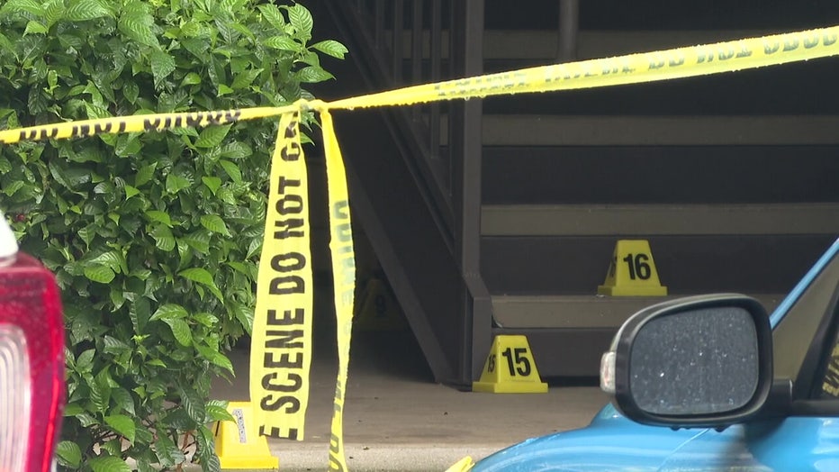 Crime scene tape outside apartment where a mother and daughter were killed.