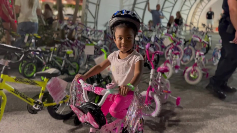 A girl receives a bike for the holidays. 