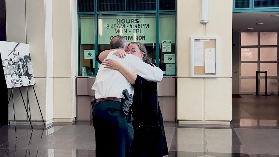 Nancy Truppner hugs Detective Zack Scott. Image is courtesy of the Broward County Sheriff's Office.