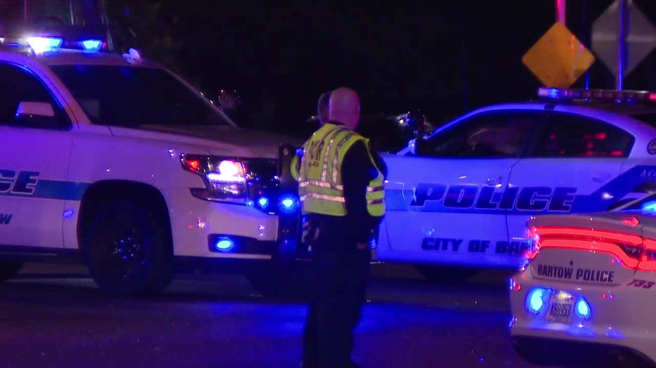 A law enforcement officer directs traffic after an officer was struck by a minivan on Sunday evening. 