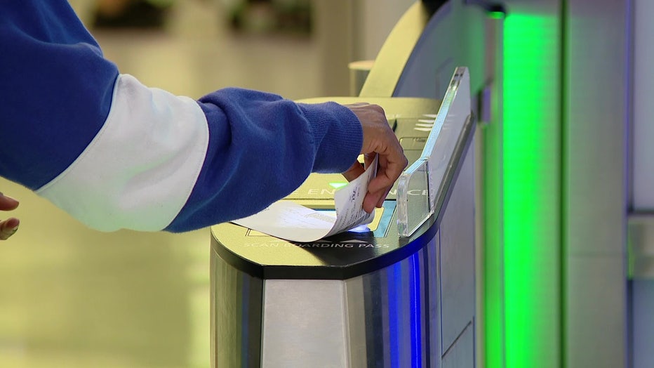 File: Traveler scans boarding pass. 