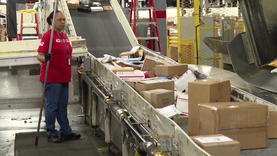 Mail handler sorts through packages in Ybor City.