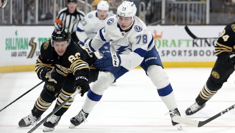 BOSTON, MA - JANUARY 06: Boston Bruins center Oskar Steen (62) squeezes past Tampa Bay Lightning defenseman Emil Martinsen Lilleberg (78) during a game between the Boston Bruins and the Tampa Bay Lightning on January 6, 2024, at TD Garden in Boston, Massachusetts. (Photo by Fred Kfoury III/Icon Sportswire via Getty Images)