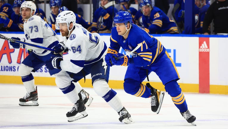 BUFFALO, NEW YORK - JANUARY 20: Tyler Motte #64 of the Tampa Bay Lightning and JJ Peterka #77 of the Buffalo Sabres skate for the puck during an NHL game on January 20, 2024 at KeyBank Center in Buffalo, New York. (Photo by Bill Wippert/NHLI via Getty Images)