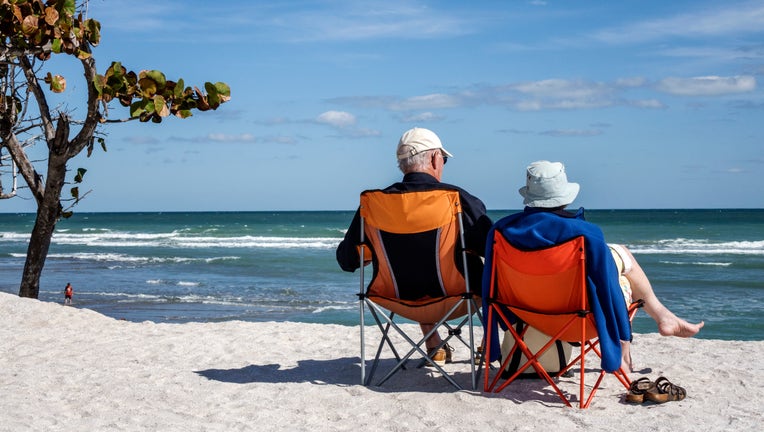 A senior couple sat on chairs on Bathtub Reef Beach. (Photo by: Jeffrey Greenberg/Universal Images Group via Getty Images)