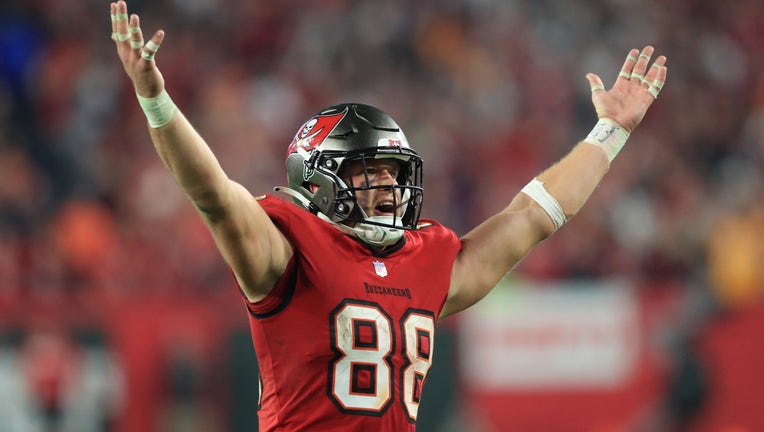 TAMPA, FL - JANUARY 15: Tampa Bay Buccaneers Tight End Cade Otton raises his hands in celebration after the Buccaneers safety during the NFC Wild Card game between the Philadelphia Eagles and the Tampa Bay Buccaneers on January 15, 2024 at Raymond James Stadium in Tampa, Florida. (Photo by Cliff Welch/Icon Sportswire via Getty Images)