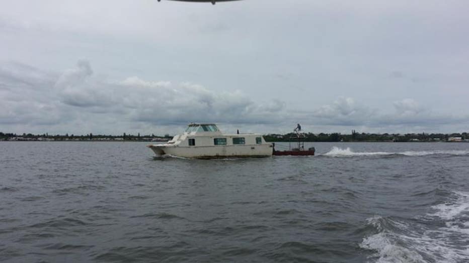 A derelict boat is removed by the Martin County Sheriffs Office. Derelict boats have long been an issue in the area, officials say, but squatters and homeless people are increasingly moving onto the vessels. (Martin County Sheriffs Office )