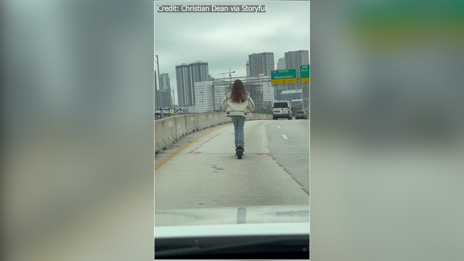A woman was recently spotted riding an electric scooter on a Miami highway. Image is courtesy of Christian Dean via Storyful. 