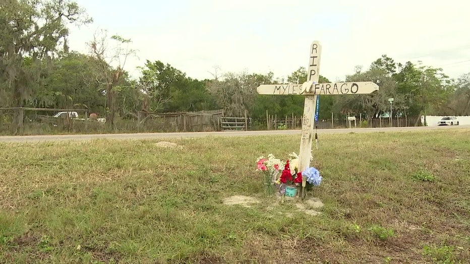 A wooden cross alongside a street is a reminder of crash fatalities.