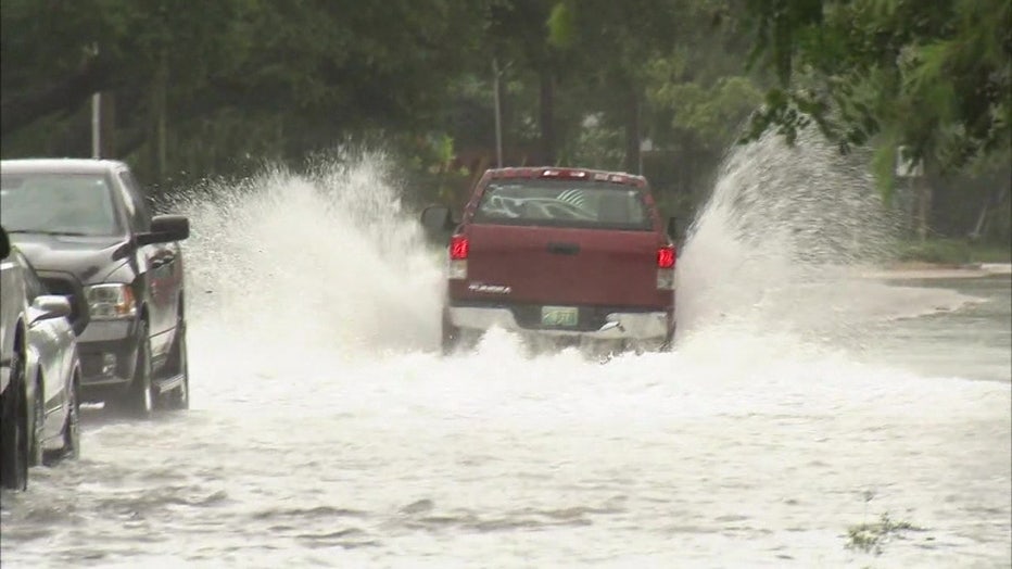 A truck drives through flood waters in Shore Acres. 