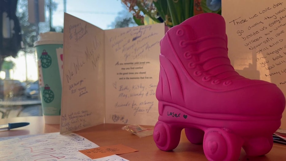 A card and a rollerskate sit on a table in honor of Wayne Liszewski.