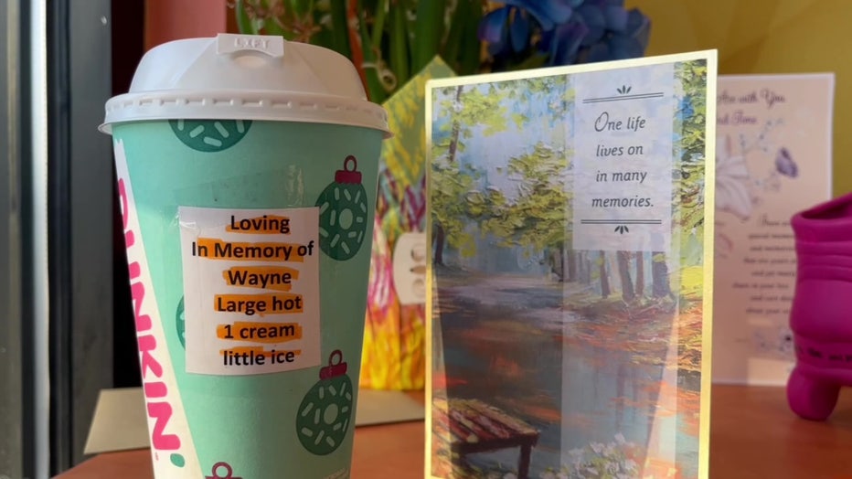 Wayne Liszewski's usual coffee sits next to a card at a table honoring the beloved rollerblader.