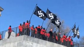 Masked demonstrators wave Nazi flags in front of Tennessee capitol