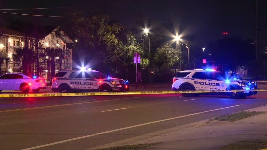 Crime scene tape and police cars at the scene of a 'road rage' shooting that injured a 4-year-old girl.