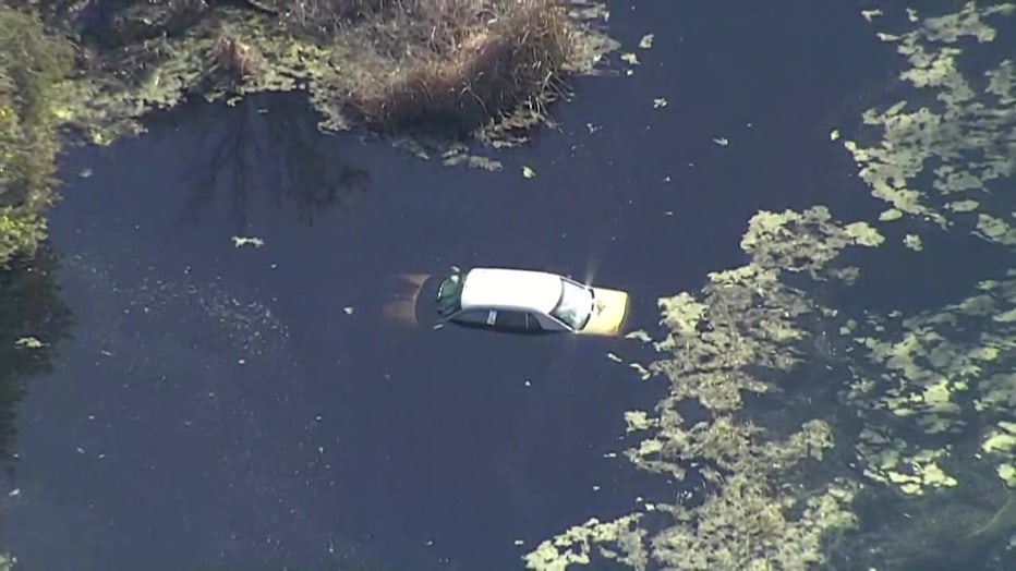 Aerial view of the suspect's car in a pond. 
