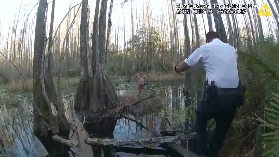 A deputy with HCSO spots the child in the swampy area. Image is courtesy of the Hillsborough County Sheriff's Office. 