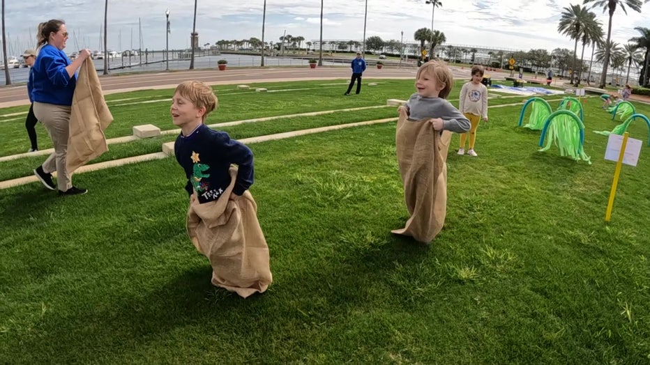 Children compete in potato sack races during the event. 