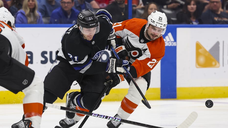 TAMPA, FL - MARCH 9: Brayden Point #21 of the Tampa Bay Lightning against Scott Laughton #21 of the Philadelphia Flyers during the first period at Amalie Arena on March 9, 2024 in Tampa, Florida. (Photo by Mark LoMoglio/NHLI via Getty Images)