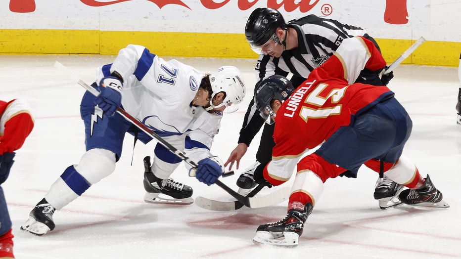 SUNRISE, FL - MARCH 16: Linesman Kilian McNamara #93 drop the puck between Anton Lundell #15 of the Florida Panthers and Anthony Cirelli #71 of the Tampa Bay Lightning at the Amerant Bank Arena on March 16, 2024 in Sunrise, Florida. (Photo by Joel Auerbach/Getty Images)