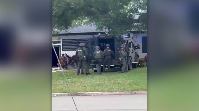 St. Pete SWAT team busts 'known drug house;' 2 arrested, 2 assault rifles recovered, police say