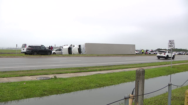 Semi-truck flips on its side during severe weather in Tampa