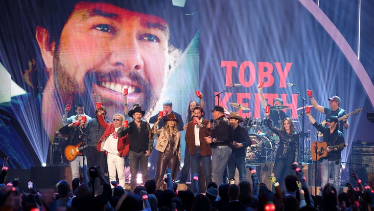 (L-R) Ronnie Dunn, Sammy Hagar, Kix Brooks, Lainey Wilson, Riley Green, Roger Clemens, Lukas Nelson Mica Roberts and Toby Keith band members toast Toby Keith onstage during the 2024 CMT Music Awards at Moody Center on April 7, 2024, in Austin, Texas. (Photo by Rick Kern/Getty Images for CMT)