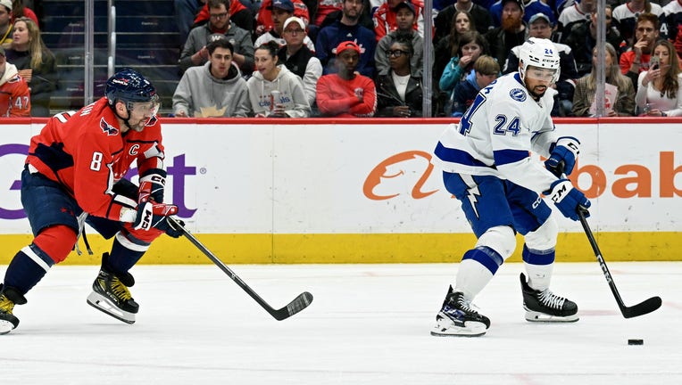 WASHINGTON, DC - APRIL 13: Washington Capitals left wing Alex Ovechkin (8) pursues Tampa Bay Lightning defenseman Matt Dumba (24) during the Tampa Bay Lightning game versus the Washington Capitals on April 13, 2024 at the Capital One Arena in Washington, D.C. (Photo by Mark Goldman/Icon Sportswire via Getty Images)